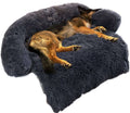 Large dark grey plush dog bed featuring a sleeping dog, designed for comfort and support with cozy curved edges.